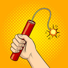 Hand with dynamite pop art vector illustration