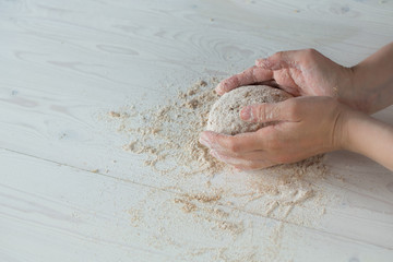 Child hands on white background molds, rolls  dough pizza