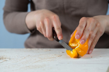 cook cuts with a sharp knife sweet yellow bell pepper