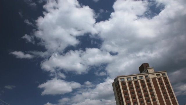 Time lapse of heritage building with rolling clouds on a sunny day.