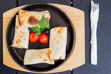 Arabian dough, wrapped chicken with decoration of tomato and lettuce, traditional dish, restaurant, specialties, kitchen, chef, served