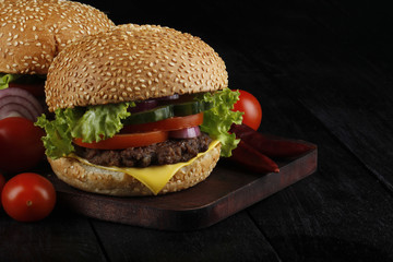 hamburger with vegetables on wooden table