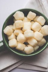Chena Murki is indian sweet food served in ceramic bowl over moody background. selective focus