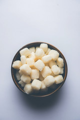 Chena Murki is indian sweet food served in ceramic bowl over moody background. selective focus