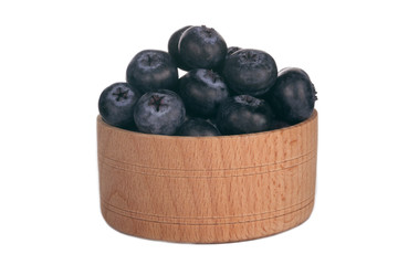 heap of blueberry in wooden cup isolated on white background