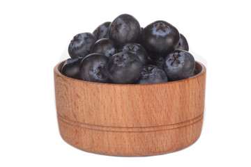heap of blueberry in wooden cup isolated on white background