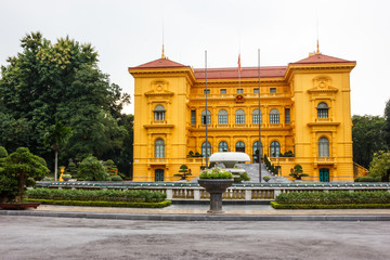 The Presidential Palace of Vietnam in Hanoi, is the three-storied, mustard yellow building built in colonial French architectural style, an orchard, carp pond, and boulevard surrounded by lush gardens