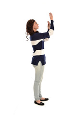  full length portrait of girl wearing striped blue and white jumper and jeans. standing pose on white studio background