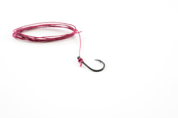 Fishing hook with a red rope on a white background.