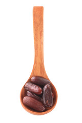 date fruits in wooden spoon isolated on white background