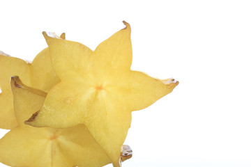 Fototapeta premium heap of slices of yellow starfruit (carambola) isolated