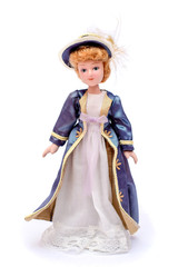 Porcelain doll in vintage white dress and a purple cape and hat