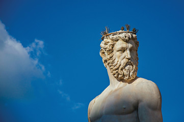 Fototapeta premium Close-up of marble head of statue in Fontana del Nettuno (Neptune fountain) at sunset. In the city of Florence, the famous and amazing capital of the Italian Renaissance. Located in the Tuscany region