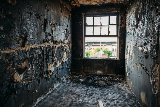 Burned and ruined house interior after fire, consequences of fire disaster accident