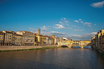 Overview of the river Arno, buildings and the Ponte Vecchio (bridge) at sunset. In the city of Florence, the famous and amazing capital of the Italian Renaissance. Located in the Tuscany region