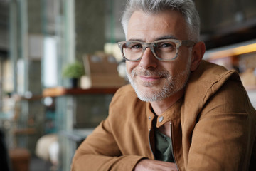 Portrait of smiling middle-aged man with eyeglasses