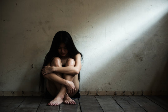 Stressed Asian woman in  dark room