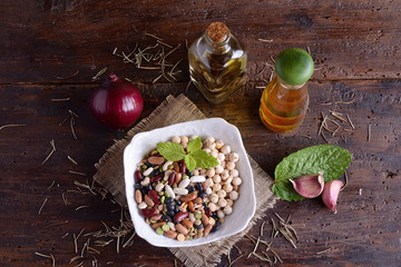 Bowl with mixed legumes and aromatic oil 