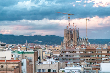 Aerial view of Barcelona skyline with Sagrada Familia under construction at sunset