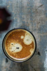black coffee and foam in a transparent steklnny cup (portion of hot coffee)