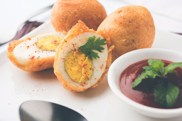 Tasty Egg Pakora or Pakoda served with tomato ketchup