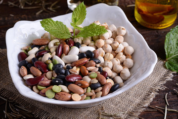 Bowl with mixed legumes and aromatic oil 