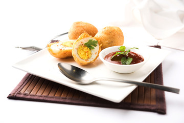 Tasty Egg Pakora or Pakoda served with tomato ketchup