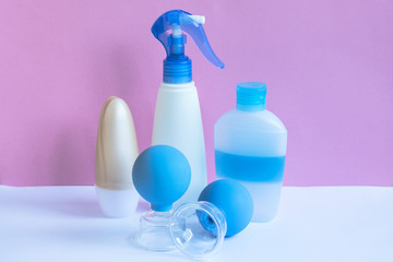 Plastic bottles and massage jars on pastel modern interior. Hygiene cosmetic concept.