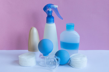 Plastic bottles and massage jars on pastel modern interior. Hygiene cosmetic concept.