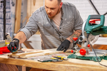 the carpenter covers by varnish a wooden item