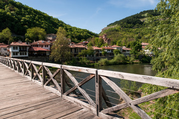 Fototapeta na wymiar Old wooden bridge - famous landmark of Veliko Tarnovo, old capital of Bulgaria. Photo was taken at sunny spring day.