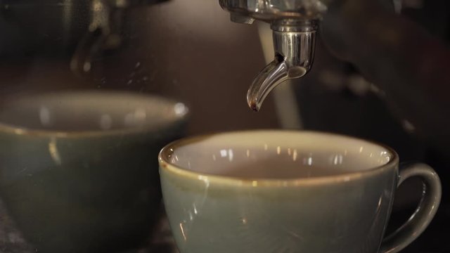 coffee pouring into cup fro coffee machine