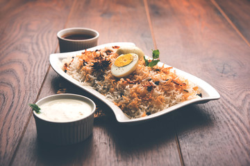 Authentic Fish Biryani served in a white plate over white background, selective focus