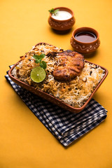 Authentic Fish Biryani served in a white plate over white background, selective focus