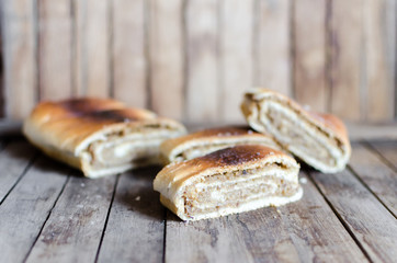 rustic poppy seeds strudel slices on wooden table