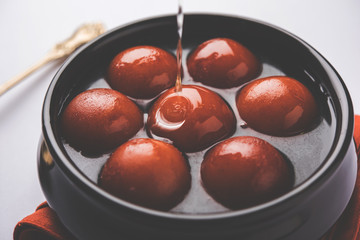 Sweet Gulab Jamun in terracotta bowl