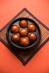 Sweet Gulab Jamun in terracotta bowl