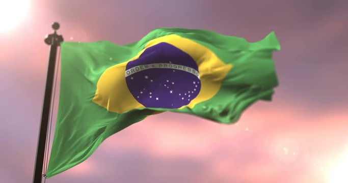 Flag of Brazil waving at wind in slow at sunset, loop