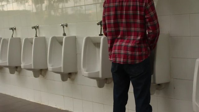 A man walking to Urinal for happy urine in the Toilet place concept.