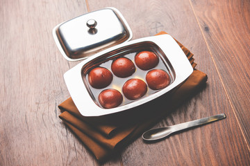 Sweet Gulab Jamun in terracotta bowl