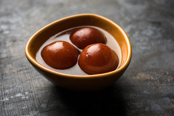 Sweet Gulab Jamun in terracotta bowl