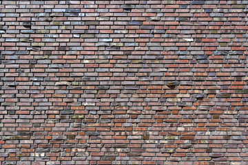 Most of the Brick wall. Decorative masonry using curves, non-standard bricks. Brick wall background. Horizontal orientation of the frame