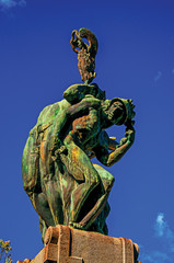 Close-up of bronze sculpture with blue and sunny sky. In a square at the Orvieto city center, an...