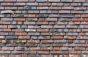 Close-up of a Brick wall. Decorative masonry using curves, non-standard bricks. Brick wall background. Horizontal orientation of the frame