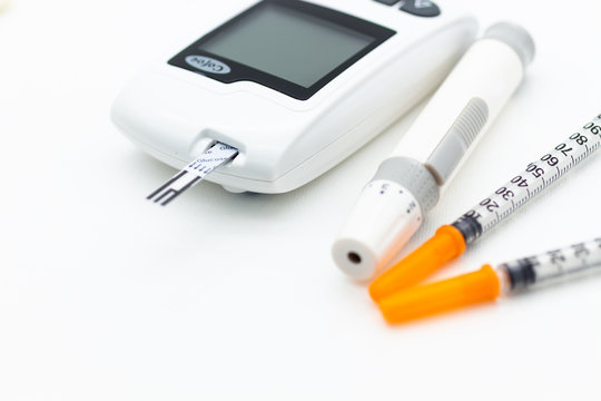 Closeup glucose meter and syringe. Image use for medicine, diabetes, health care concept.
