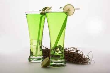 Khus Sharbat or Vetiver Drink served in a glass with Mint and Lemon slice, selective focus