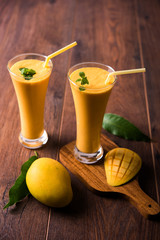 Mango Lassi, Indian popular summer drink in a terracotta glass, selective focus