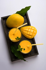 Mango Lassi, Indian popular summer drink in a terracotta glass, selective focus