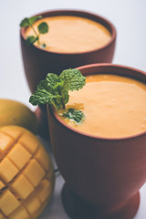 Mango Lassi, Indian popular summer drink in a terracotta glass, selective focus