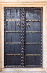 Fototapeta na wymiar Antique rustic ancient wooden door. Architectural element.